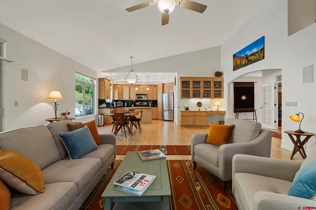 a living room with furniture fireplace and a table
