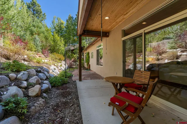 a view of a backyard with plants and outdoor seating