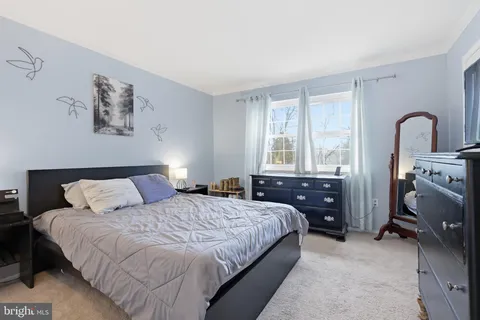 a bedroom with a bed and a desk