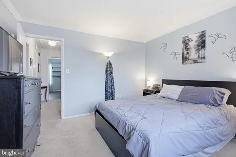 a bedroom with a bed and a view of bathroom