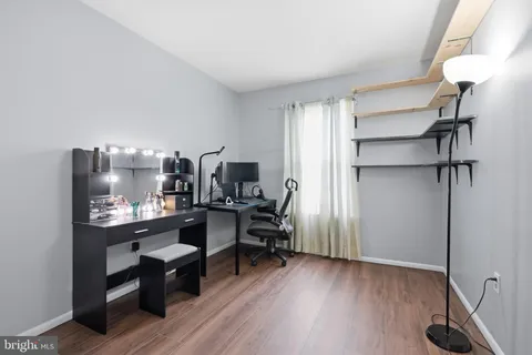 a view of a workspace with furniture and wooden floor