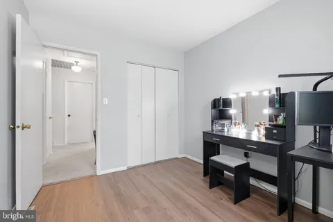 a view of a workspace with furniture and wooden floor