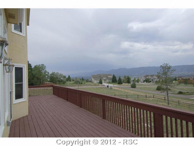 17710 New London Road Monument, CO 80132 - Photo 14 of 15 Amazing views on a clearer day. This deck runs the length of the home, all of 47 feet. It is 16 feet deep, and shows off the Rampart Range views from Cheyenne Mountain to Palmer Divide.