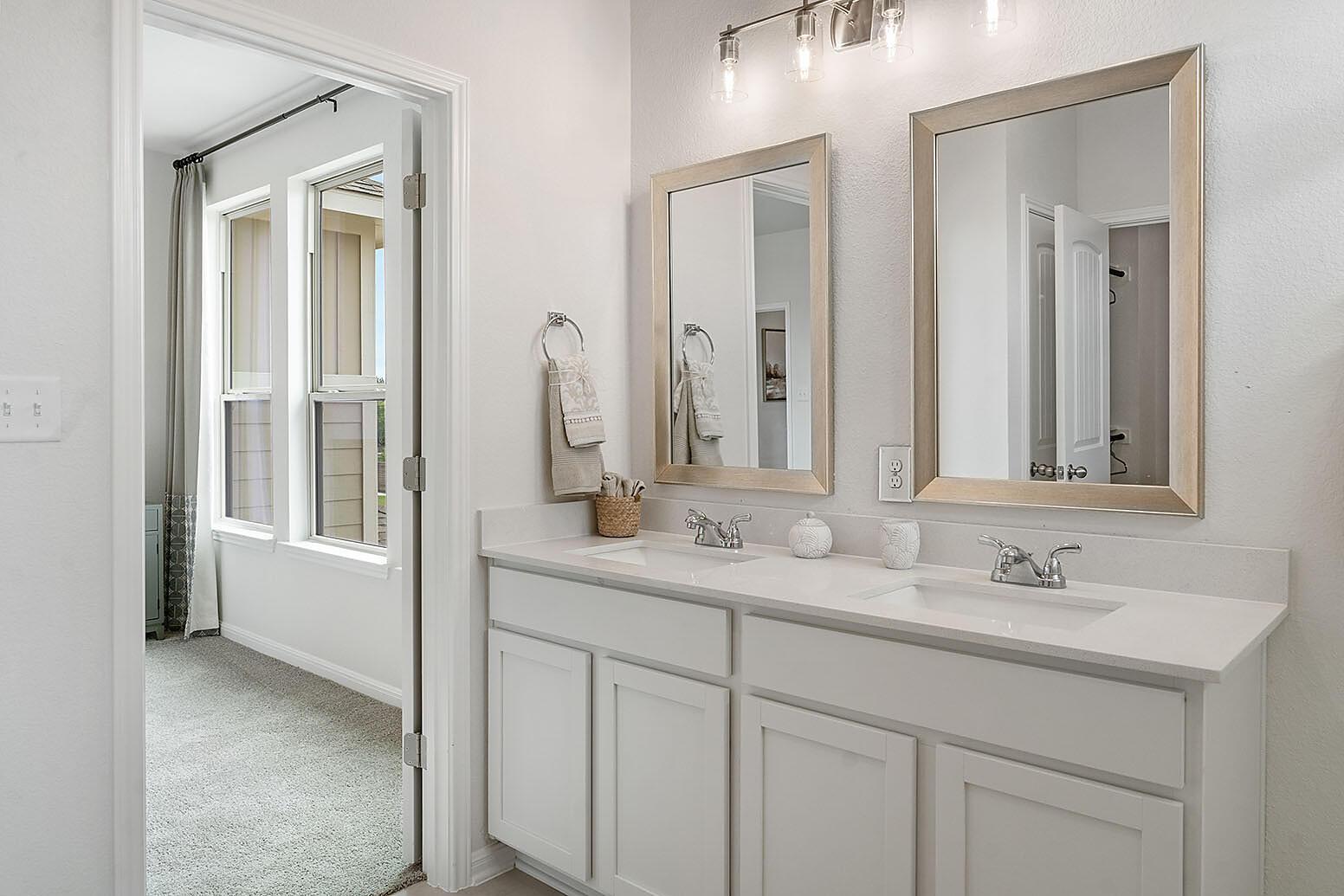 20603 B Combine Path Pflugerville, TX 78660 - Photo 14 of 19 Double vanity with quartz countertops and dual framed mirrors elevate this pristine bathroom.