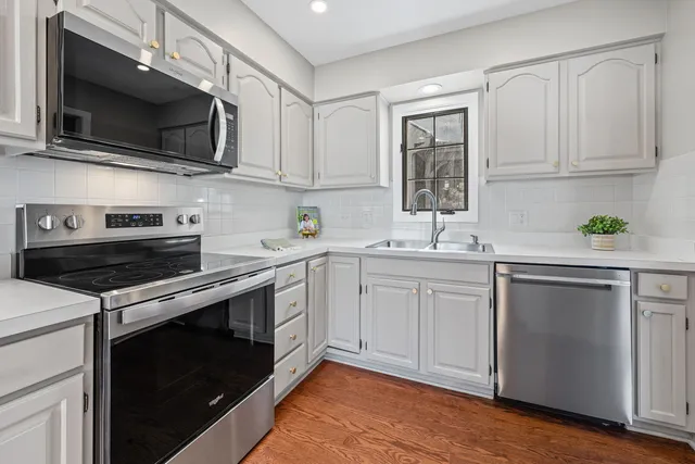a kitchen with a sink stove and microwave