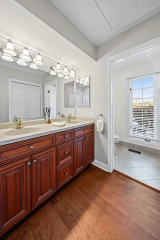 a spacious bathroom with a double vanity sink and a mirror