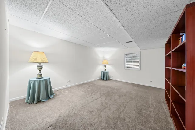 a view of empty room with windows and fan