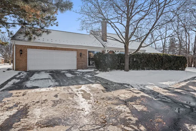 a view of a yard covered with snow in front of house