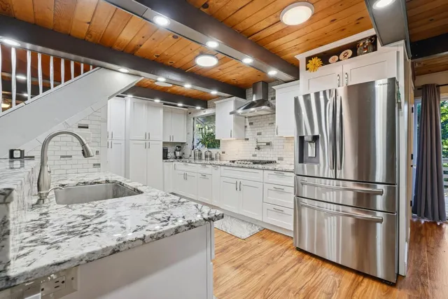 a backyard of a house with a table and chairs