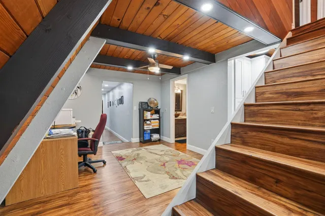 a bedroom with a bed window and a flat tv screen