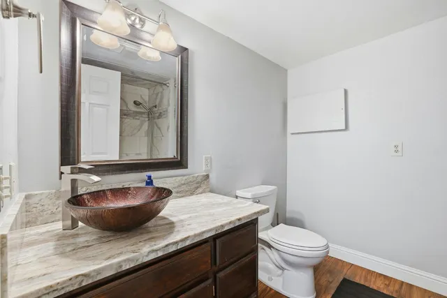 a bedroom with a bed dresser and a window