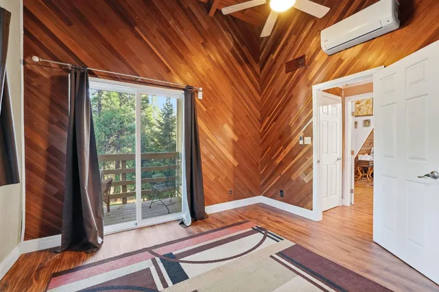 a view of a house with a yard and large trees