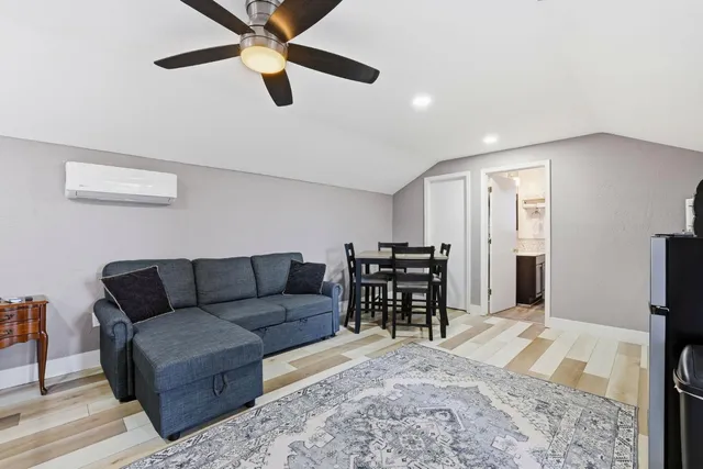 a view of a deck with chairs a barbeque with wooden floor and fence