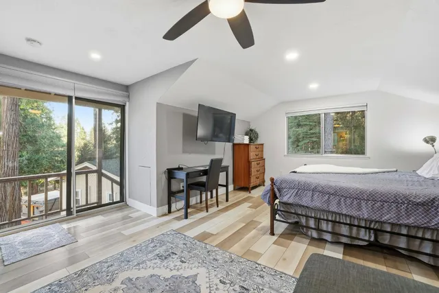 a view of deck with furniture and trees