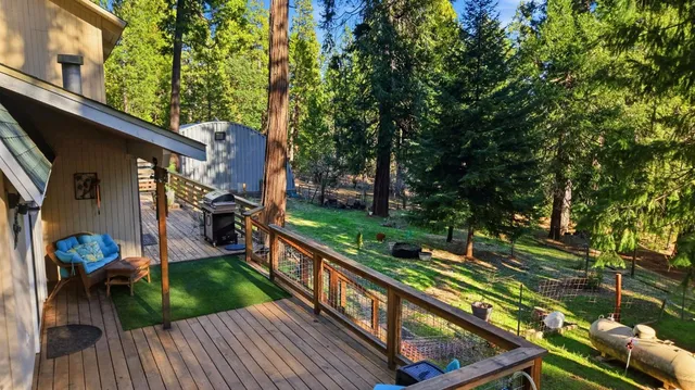 a view of a wooden house with large trees