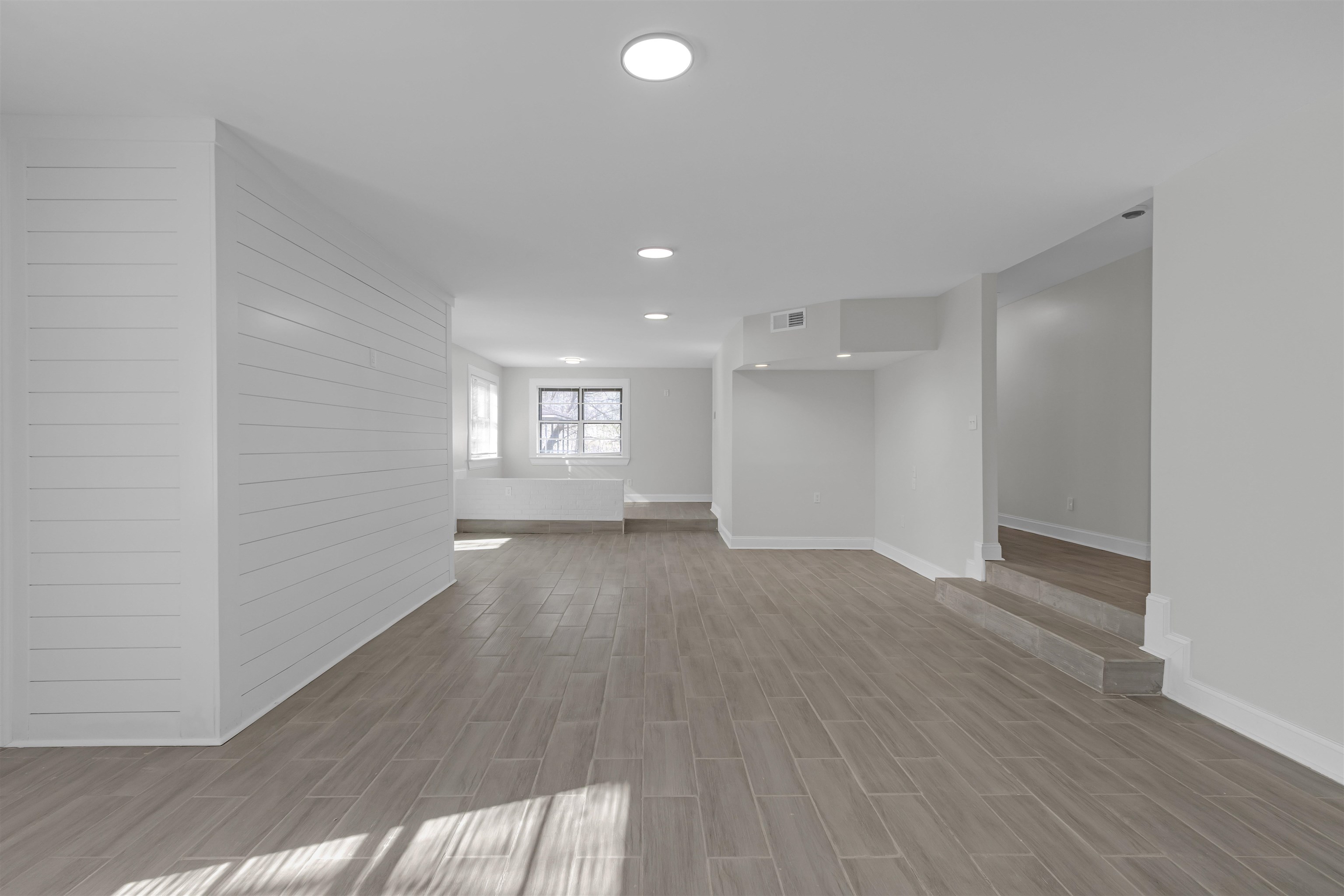 1296 Monasco Road Millington, TN 38053 - Photo 7 of 32 a view of empty room with wooden floor and fan