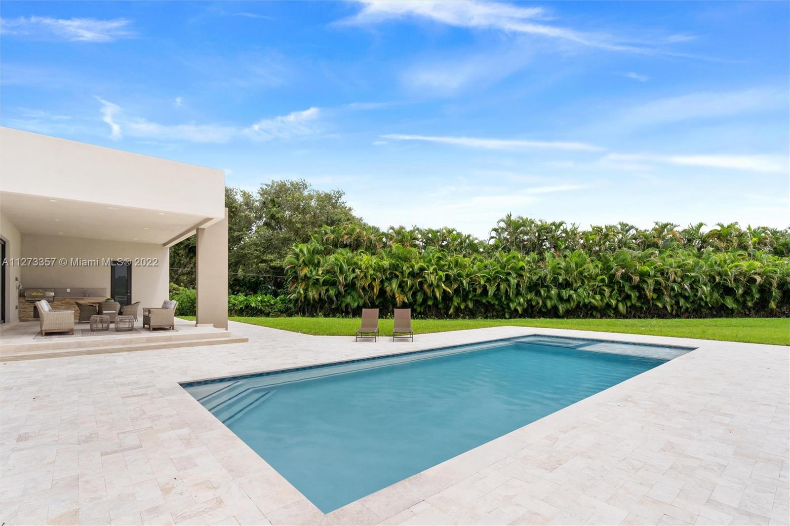 6100 Stallion Way Southwest Ranches, FL 33330 - Photo 54 of 80 a view of a swimming pool with an outdoor space and seating area