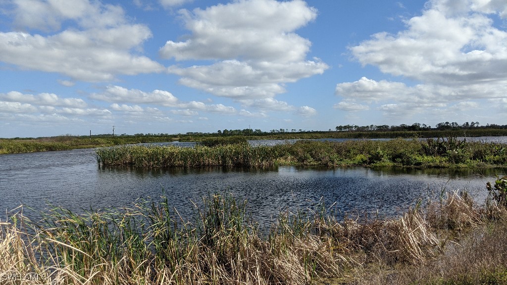 6450 Sears Road LaBelle, FL 33935 - Photo 3 of 5 a view of a lake with houses in the back