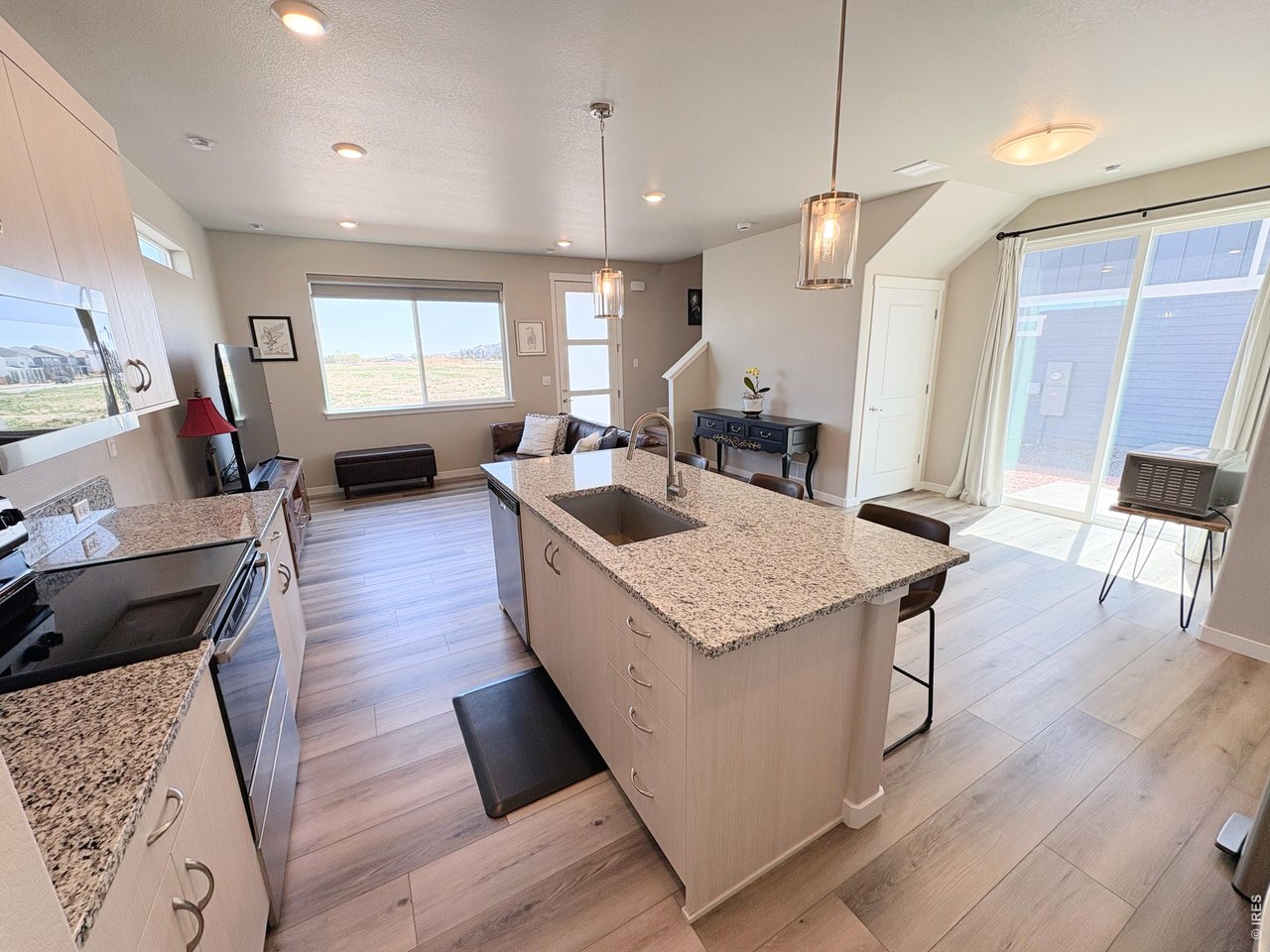 333 Pyramid Peak Street Berthoud, CO 80513 - Photo 4 of 21 a kitchen with sink stove and wooden floor