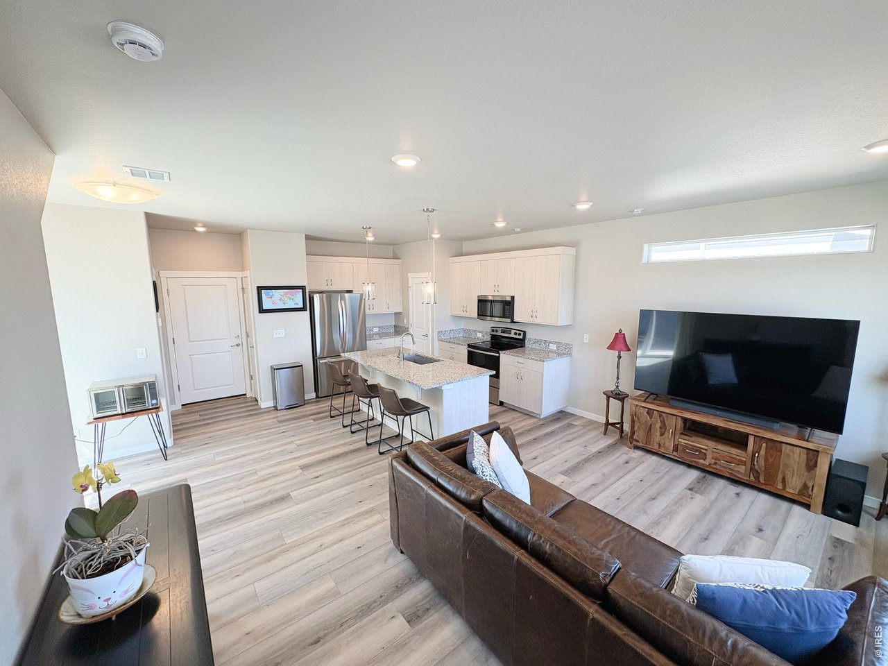 333 Pyramid Peak Street Berthoud, CO 80513 - Photo 6 of 21 a living room with furniture and a flat screen tv
