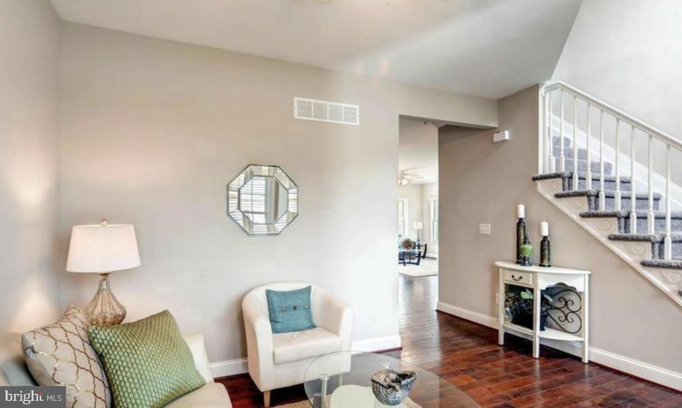 8319 Bletzer Road Baltimore, MD 21222 - Photo 4 of 7 a living room with furniture and a wooden floor