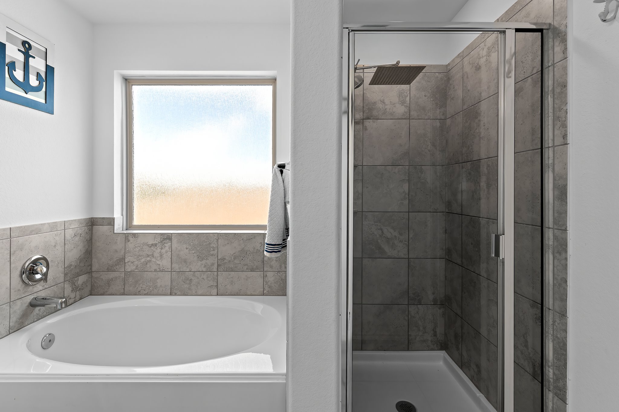 576 Greatest Gift Way Jarrell, TX 76537 - Photo 27 of 37 Indulge in a tranquil bathing experience with this spacious soaking tub and adjacent tile-surrounded shower.