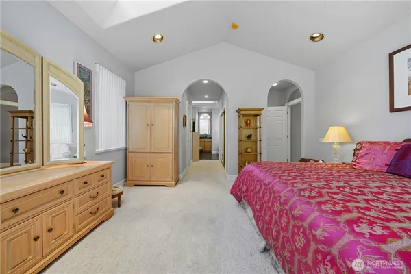 a spacious bathroom with a mirror a shower and sink
