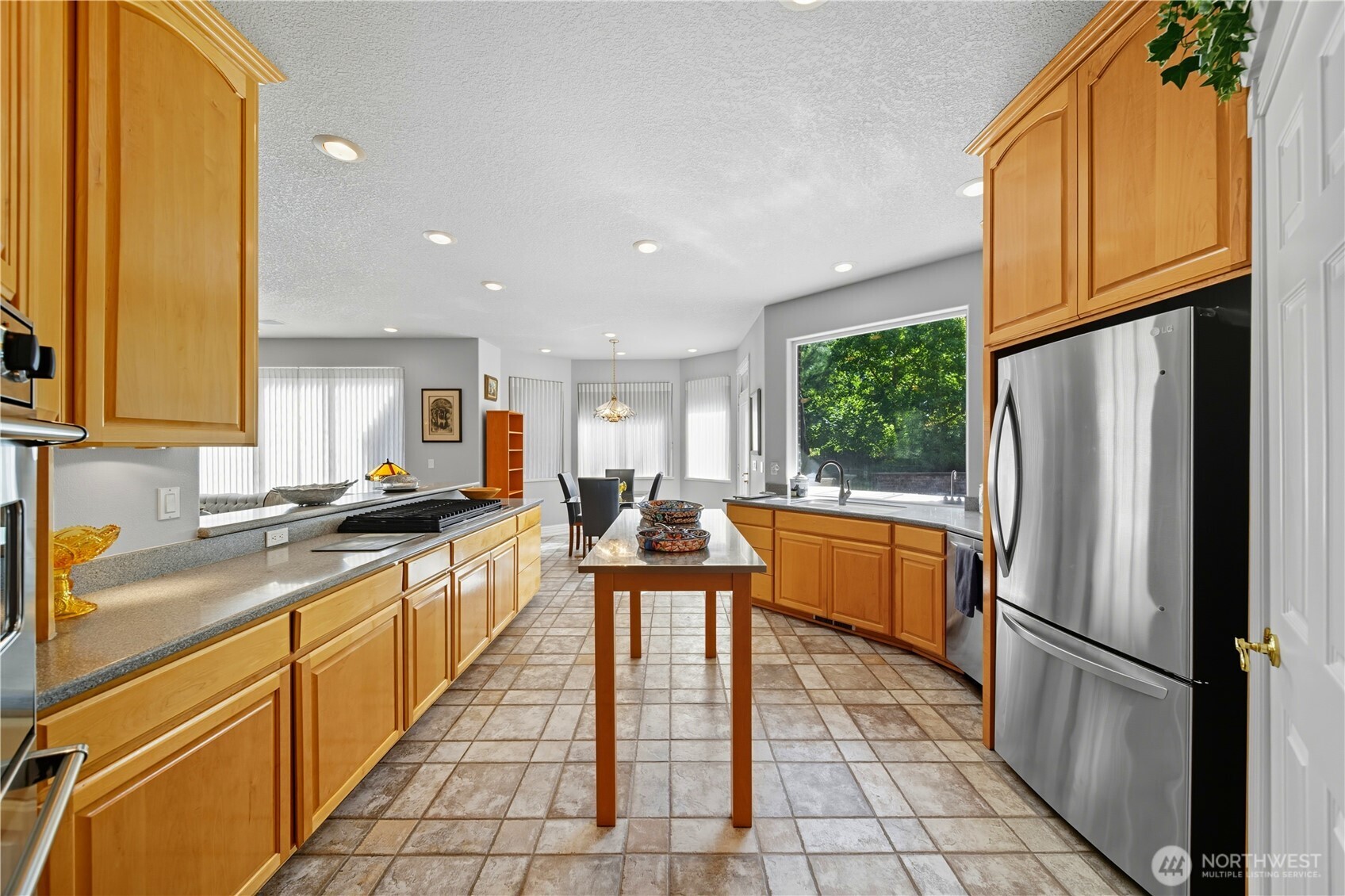 1629 Wheatcrest Road Walla Walla, WA 99362 - Photo 15 of 40 a kitchen with stainless steel appliances granite countertop a refrigerator a sink dishwasher a stove and white countertops with wooden floor