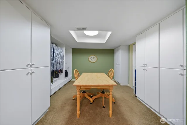 a living room with furniture a flat screen tv and gym equipment