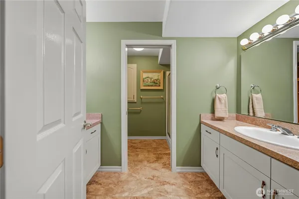 a spacious bedroom with a bed and window