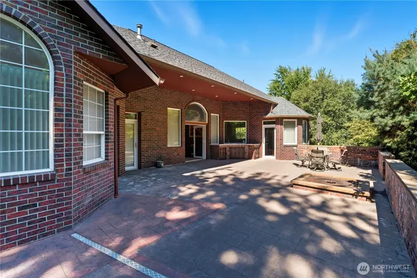 a swimming pool with outdoor seating and yard