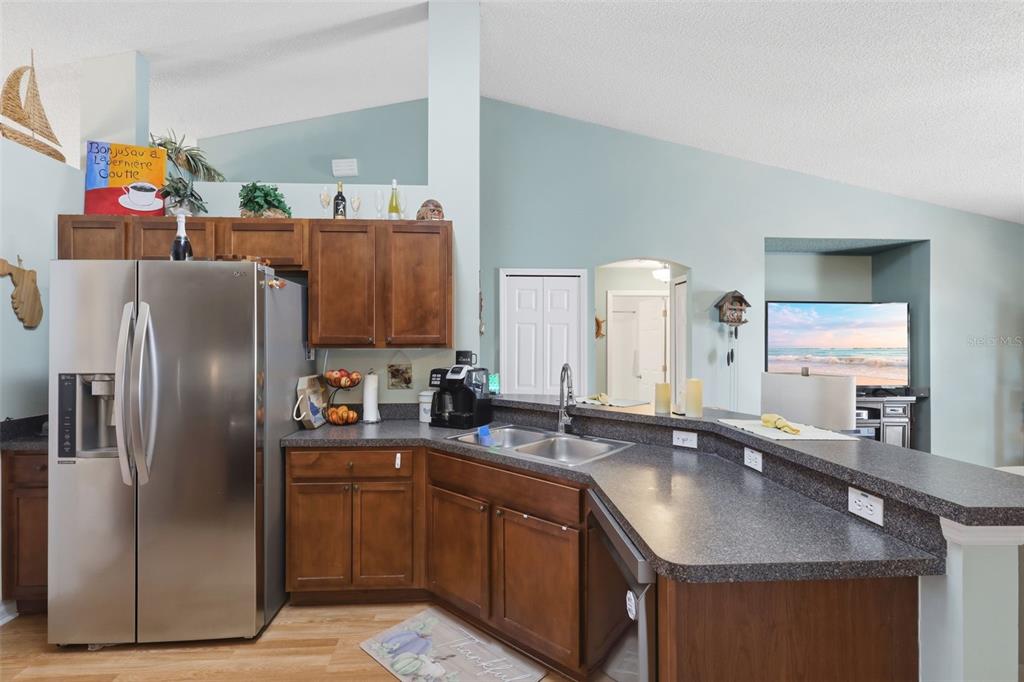 403 Central Mariners Drive Edgewater, FL 32141 - Photo 15 of 42 a kitchen with stainless steel appliances granite countertop a sink a refrigerator and a counter space