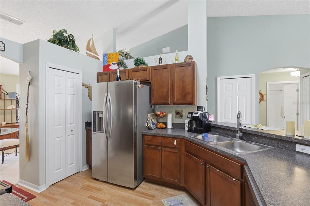 403 Central Mariners Drive Edgewater, FL 32141 - Photo 16 of 42 a kitchen with stainless steel appliances granite countertop a refrigerator and a sink