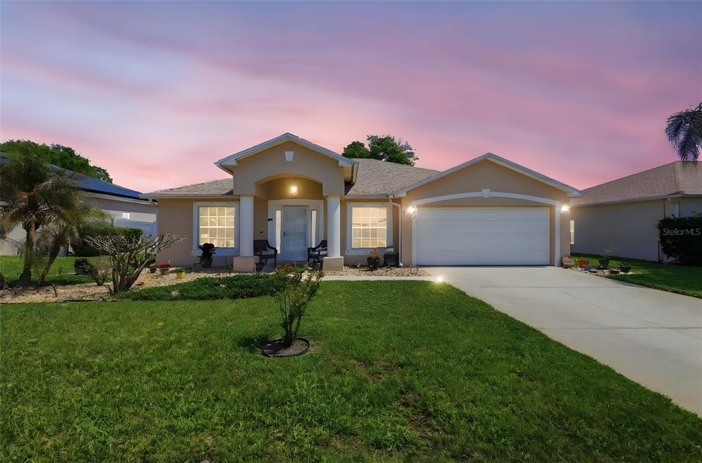 403 Central Mariners Drive Edgewater, FL 32141 - Photo 2 of 42 a front view of a house with a yard and garage