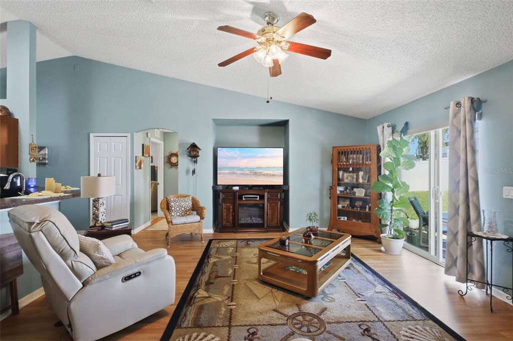 403 Central Mariners Drive Edgewater, FL 32141 - Photo 24 of 42 a living room with furniture a flat screen tv and a fireplace