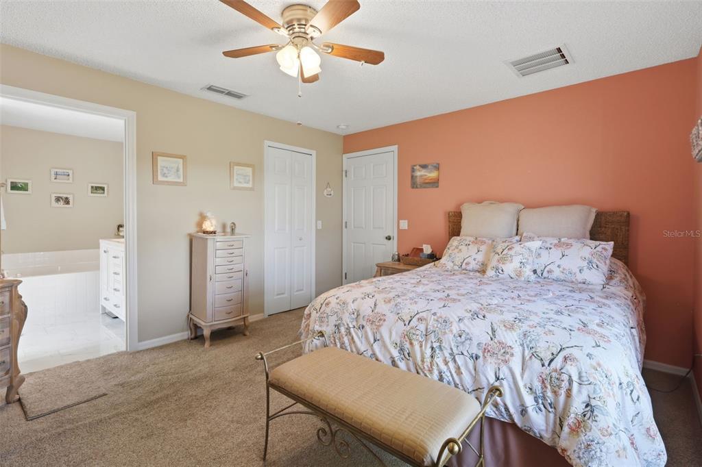 403 Central Mariners Drive Edgewater, FL 32141 - Photo 26 of 42 a bedroom with a bed and a chandelier
