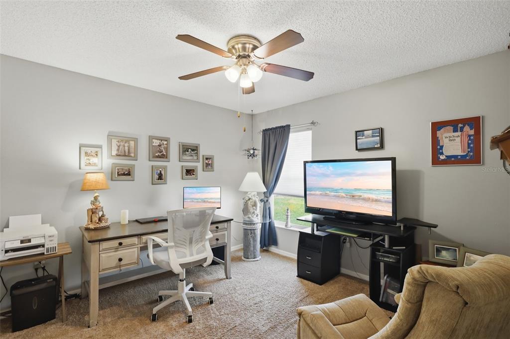 403 Central Mariners Drive Edgewater, FL 32141 - Photo 28 of 42 a room with furniture and a flat screen tv