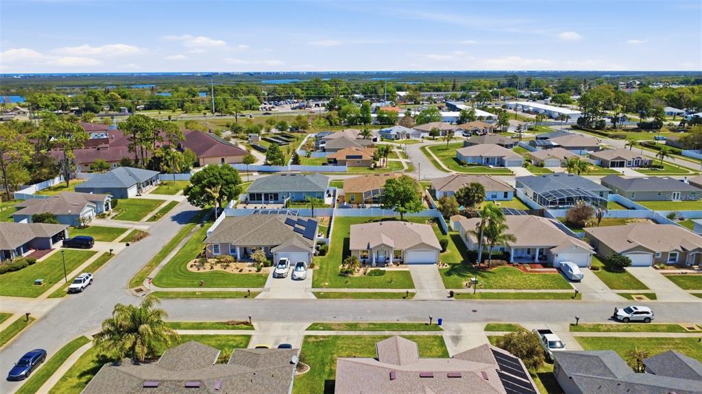403 Central Mariners Drive Edgewater, FL 32141 - Photo 38 of 42 an aerial view of a city with lots of residential buildings ocean and mountain view in back