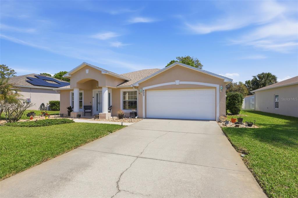 403 Central Mariners Drive Edgewater, FL 32141 - Photo 41 of 42 a front view of a house with a yard and garage