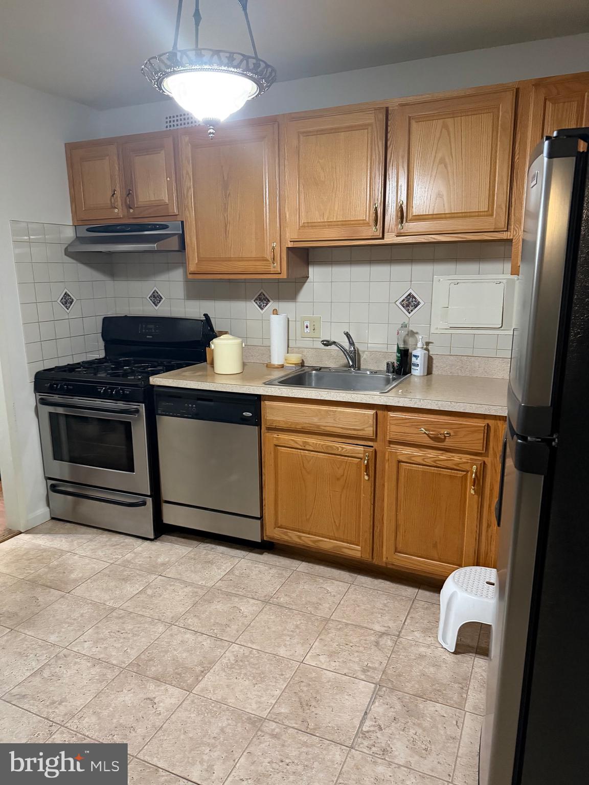 1836 Southwest Metzerott Road, Unit 1524 Hyattsville, MD 20783 - Photo 13 of 18 a kitchen with stainless steel appliances granite countertop a stove a sink dishwasher and a refrigerator