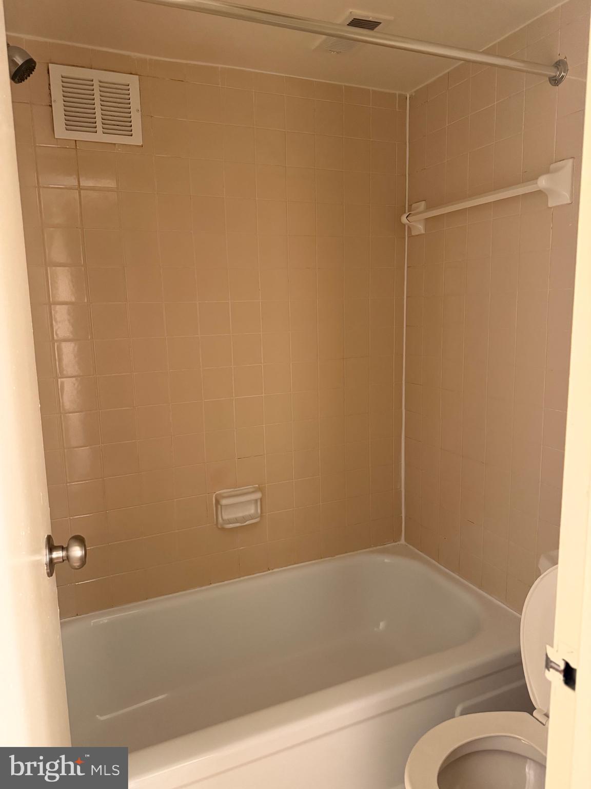 1836 Southwest Metzerott Road, Unit 1524 Hyattsville, MD 20783 - Photo 9 of 18 a bathroom with a bathtub and a toilet