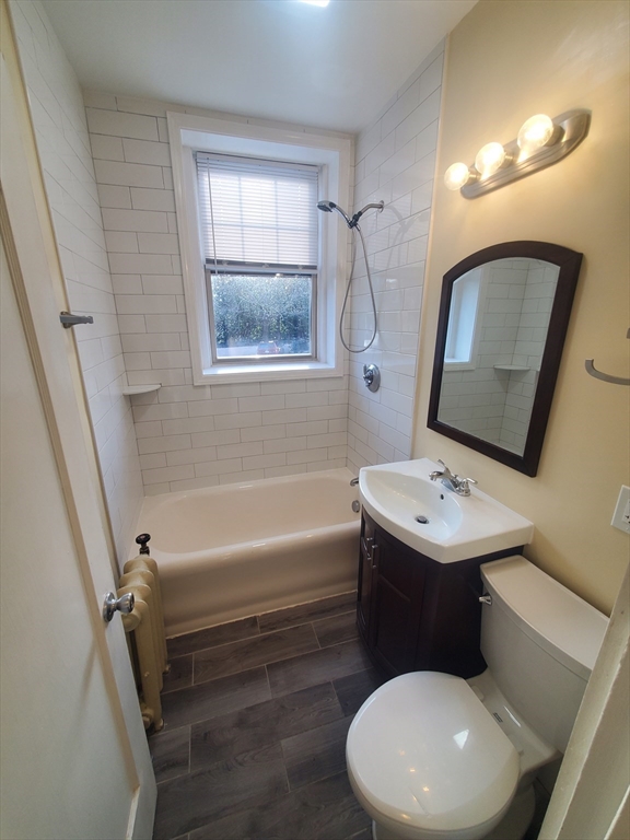 415 County Street, Unit 116 New Bedford, MA 02740 - Photo 7 of 14 a bathroom with a toilet a sink and a mirror