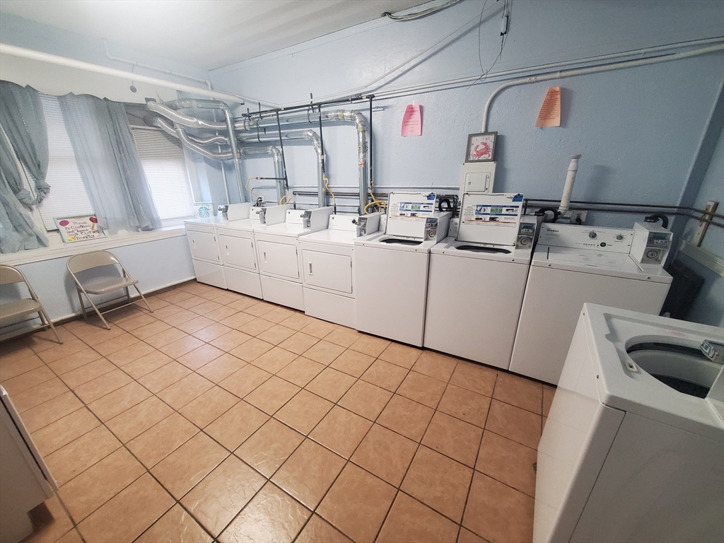 415 County Street, Unit 116 New Bedford, MA 02740 - Photo 9 of 14 a storage room with cabinets
