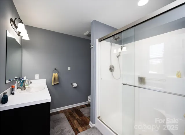 a bathroom with a double vanity sink mirror and shower