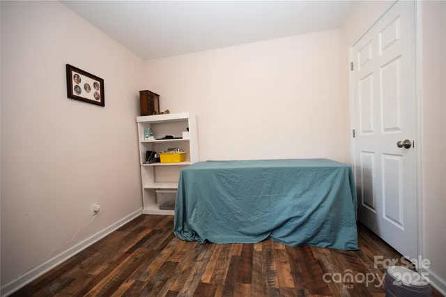 a room with a wooden floor and a stool