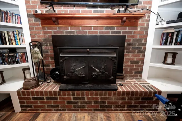 a view of living room with furniture and a fireplace