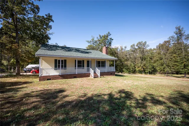 a front view of a house with yard porch and outdoor seating