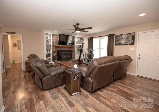 a living room with furniture fireplace and flat screen tv