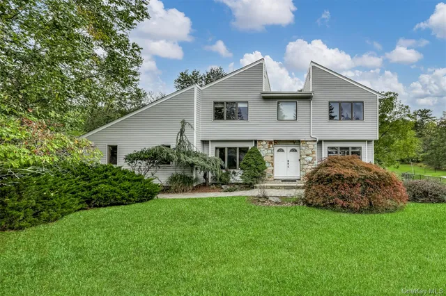 a front view of house with a garden