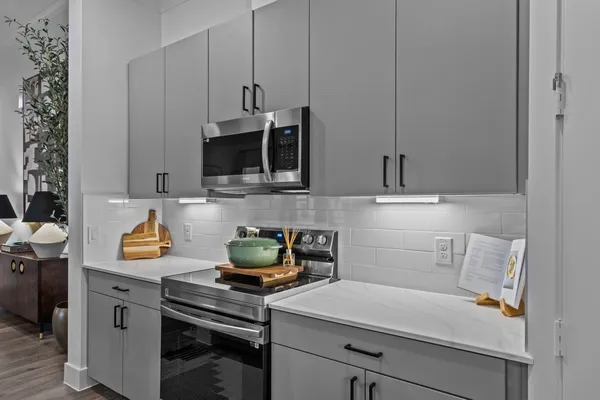 a kitchen with a sink a stove and cabinets